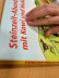 Hand, die gerade ein Kinderbuch in Punktschrift liest