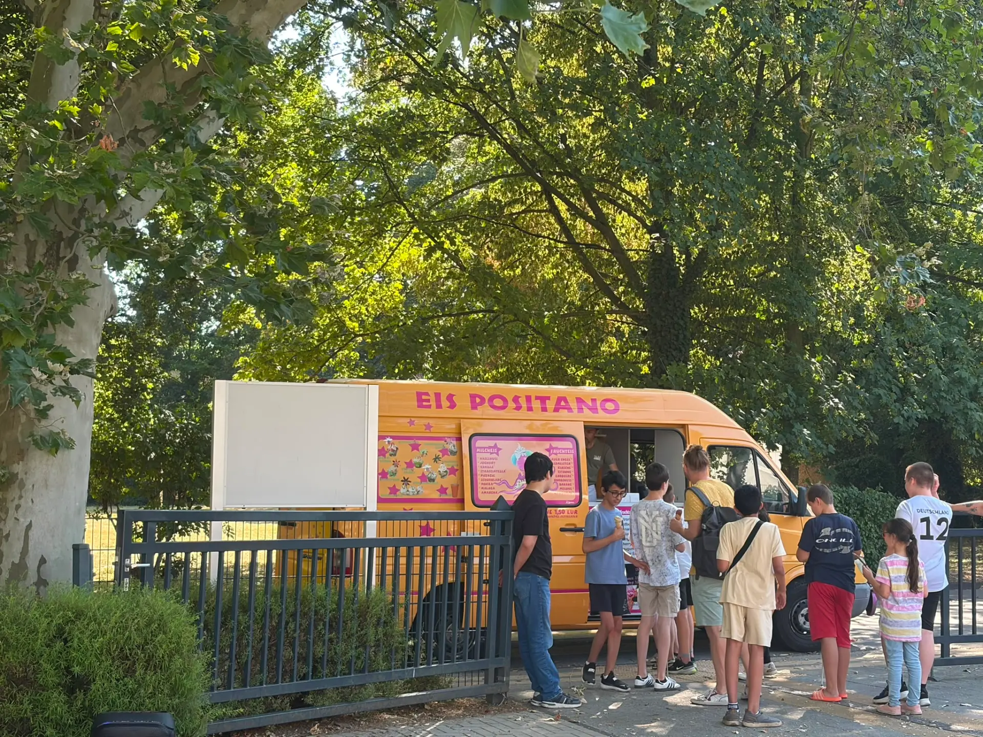 Mehrere Menschen stehen vor einem Eiswagen 